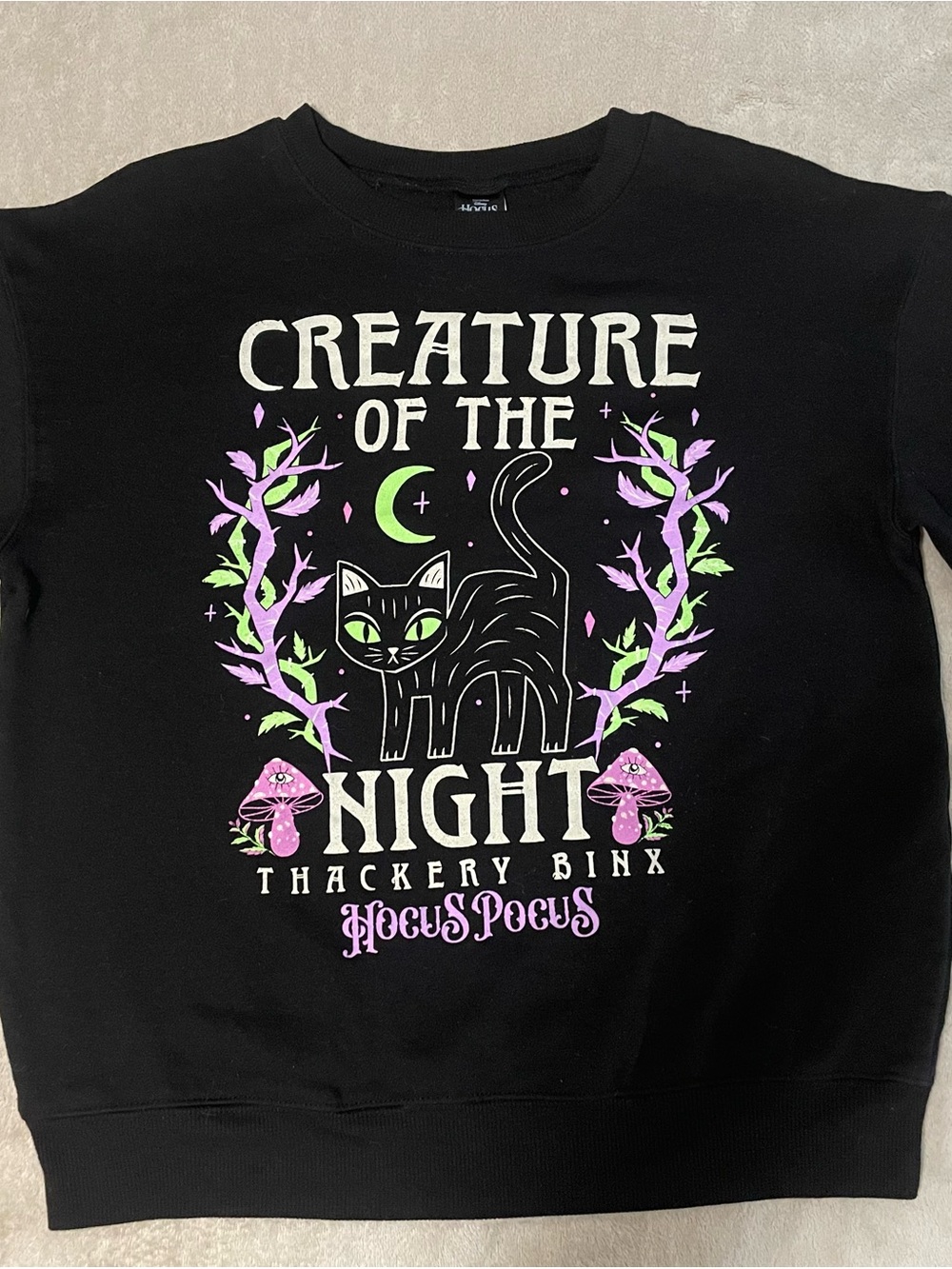 Disney Black Sweatshirt with Green-Eyed Cat and Pink Accents
